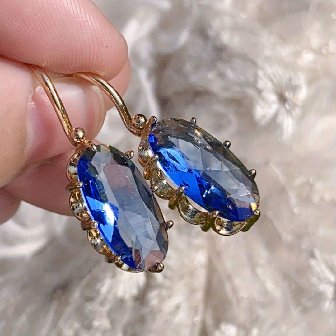 Elegante gouden oorbellen met blauwe bloem