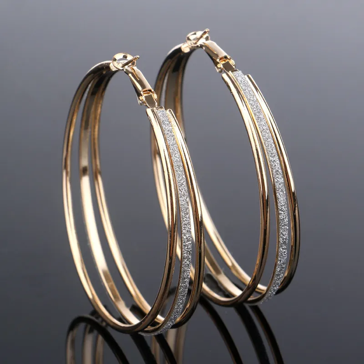 Elegante gouden oorbellen met glanzende zirkonia
